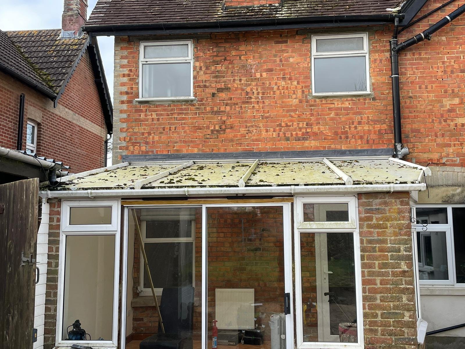 Conservatory roof covered in dirt and algae before cleaning